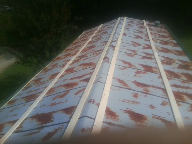 Rusted metal roof panels with new wood purlins before replacement — Storm Damage Roof Repair in Trout Creek by Roofing Brothers
